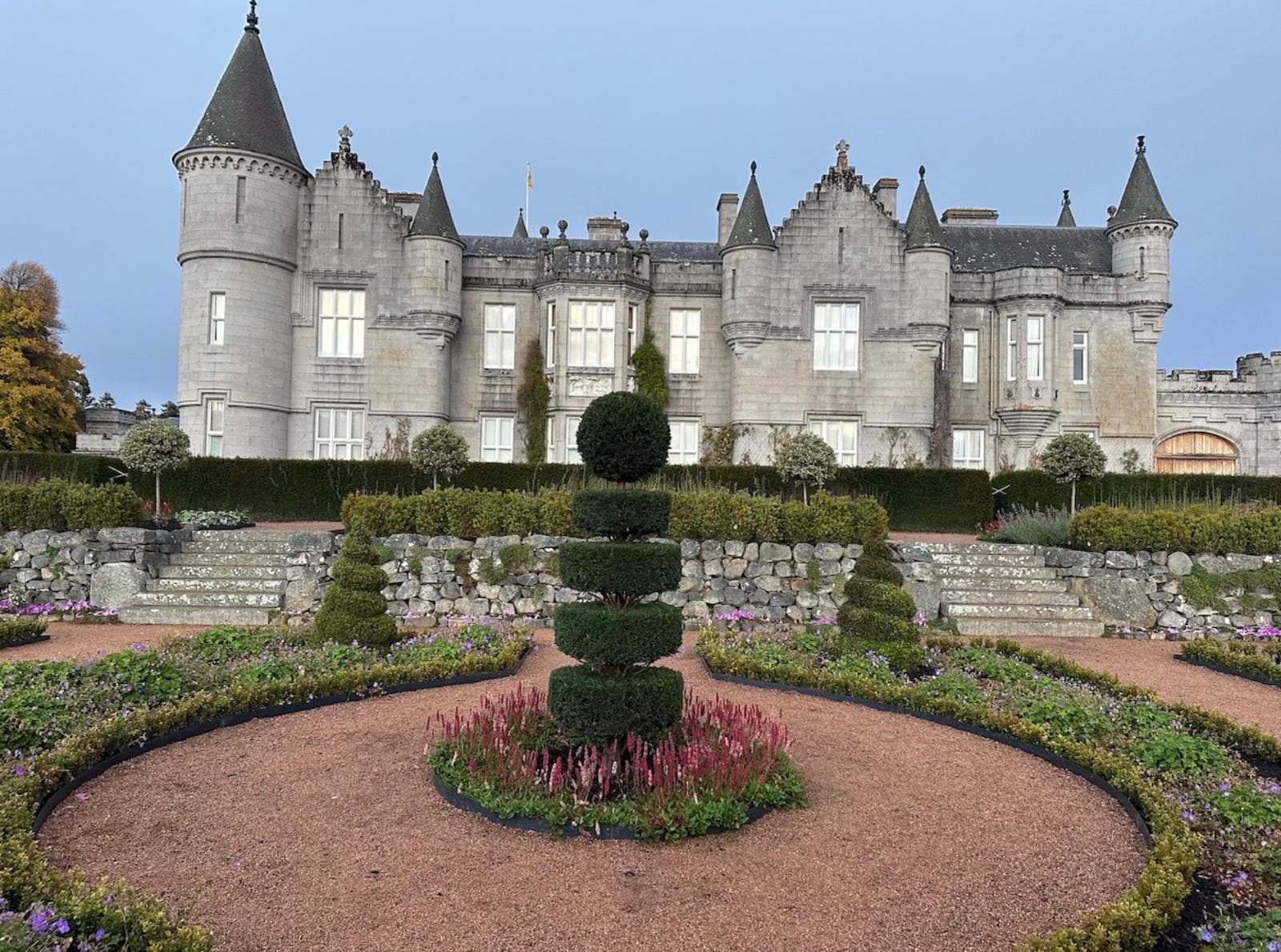 Topiary in formal garden setting with castle behind